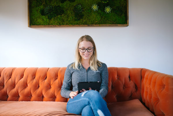 woman sitting on couch with ipad