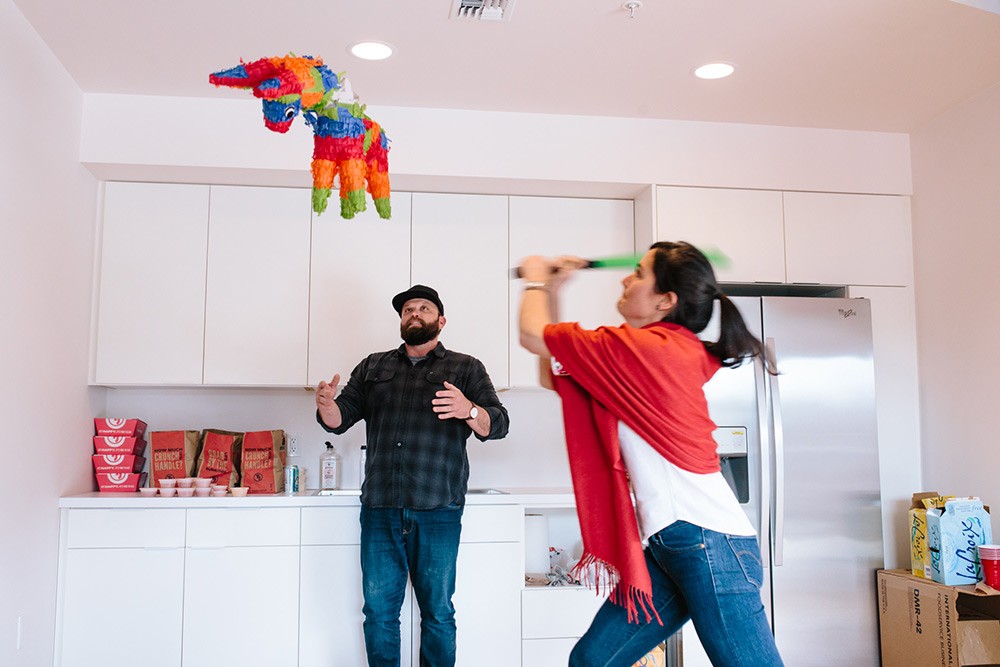 Anne of Wisetail LMS hits a pinata during a celebration.