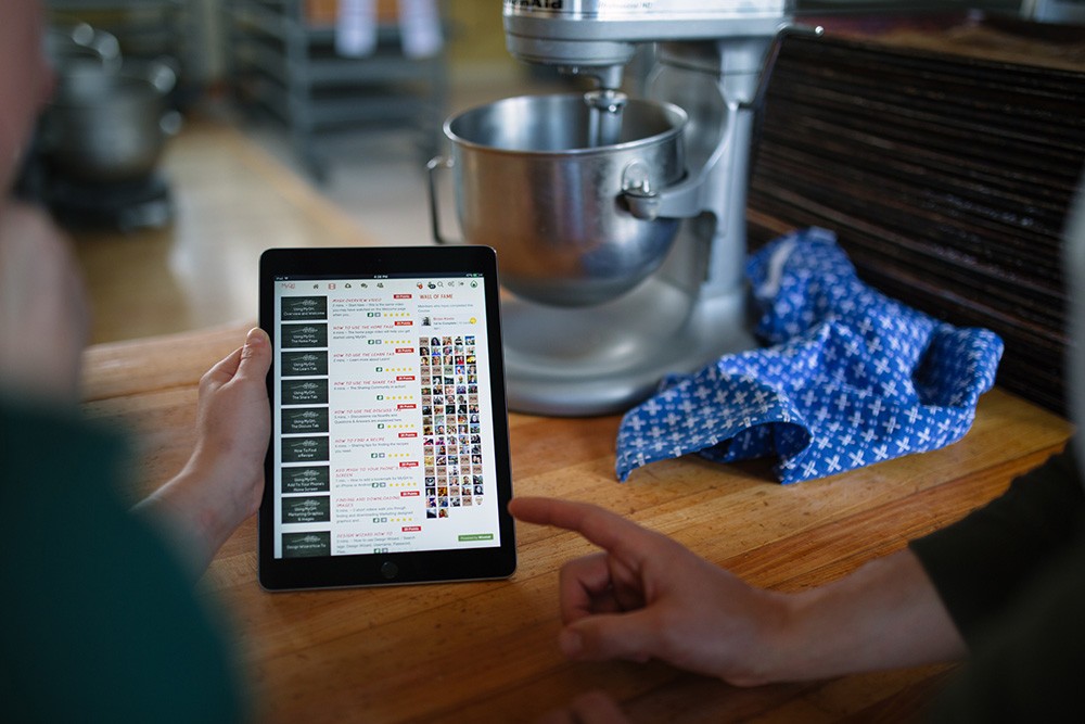 A picture of the Great Harvest Bread Company LMS that shows their social features and gamification strategies.