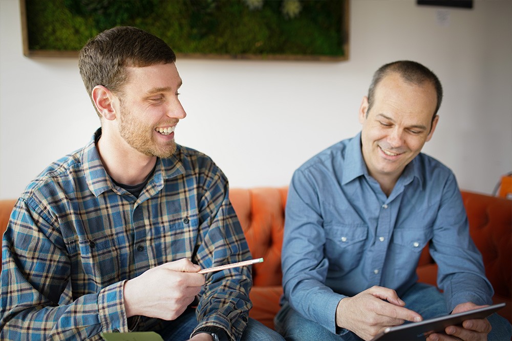 Wisetail LMS employees engage in a one-on-one in the Wisetail office.