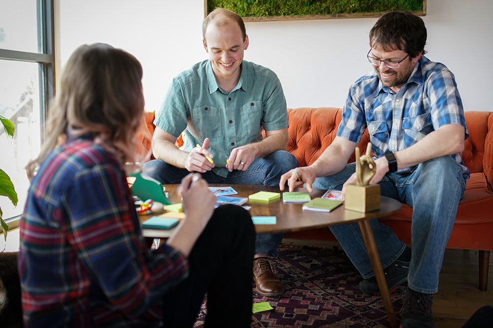 Wisetail LMS employees brainstorm around a table.