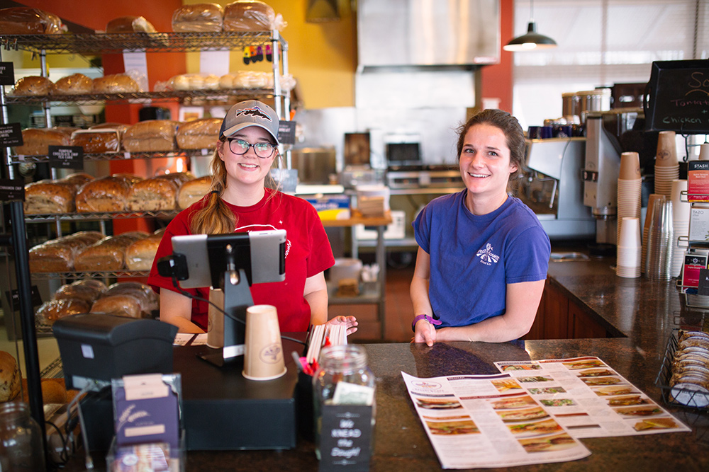 Restaurant employees train at the front counter while using their LMS.