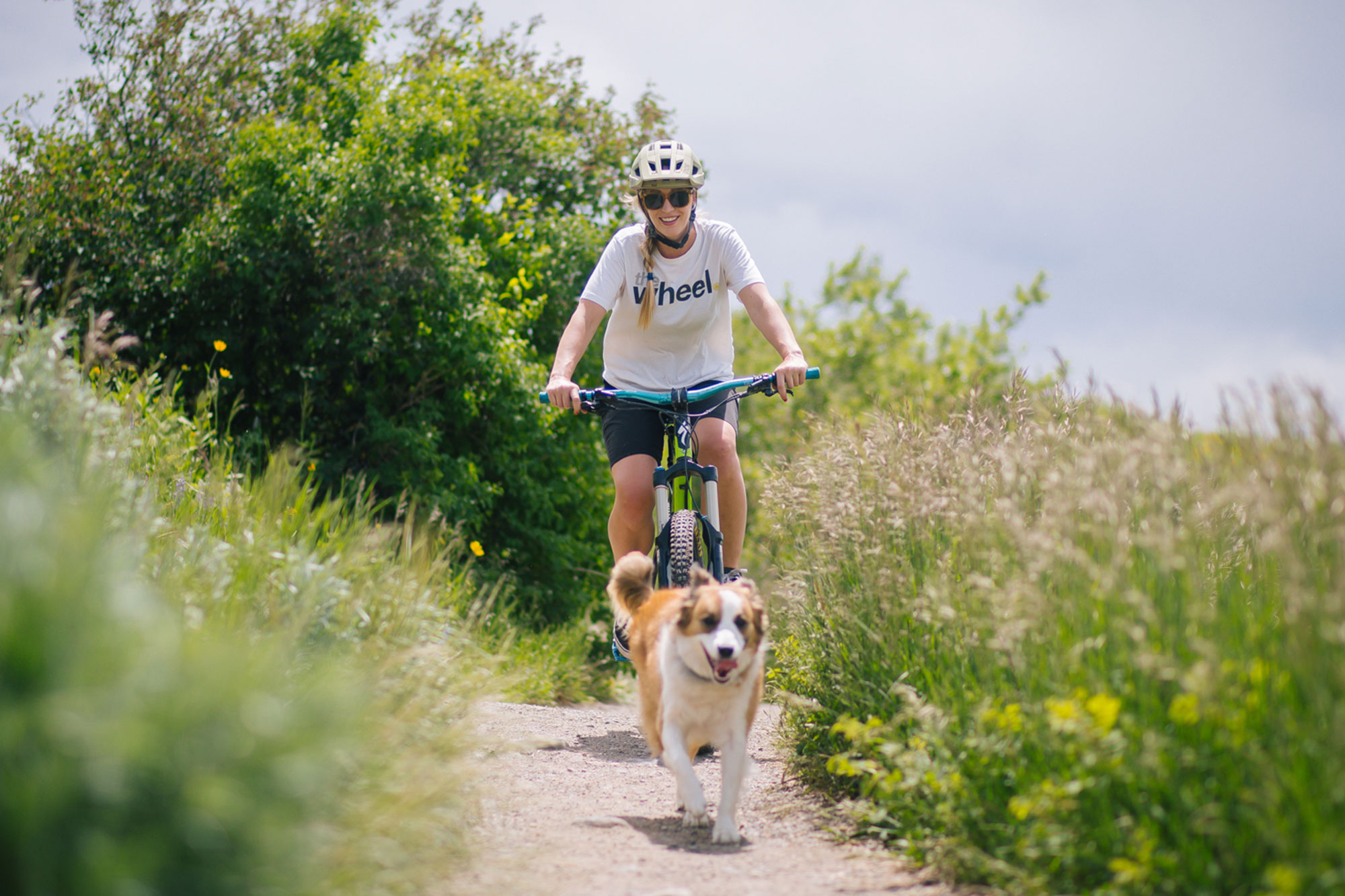 courtney-and-dog-biking on trail