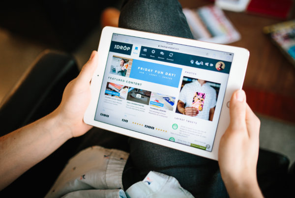 man holding a tablet with the wisetail lms platform open