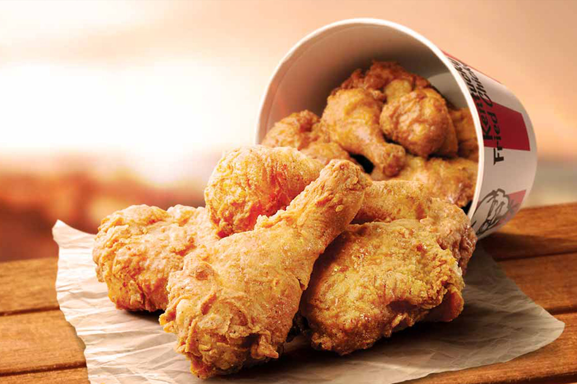 a close up of the chicken bucket from kfc a client of wisetail