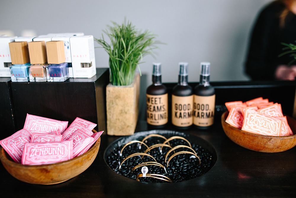 A retail display with bracelets and sprays at a store.