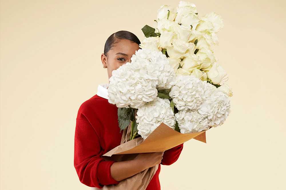 Wisetail LMS client, Hello Alfred, shows a woman carrying a bouquet of flowers.