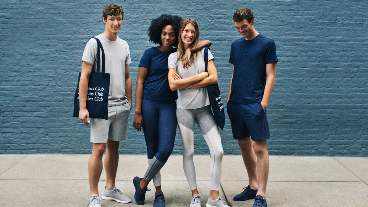 Wisetail LMS client Outdoor Voices models stand on the street and pose.