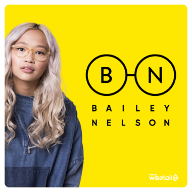 bailey nelson model wearing glasses next to bailey nelson logo on yellow bg