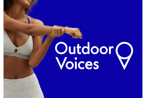 Outdoor Voices logo next to woman stretching wearing Outdoor Voices apparel on blue background