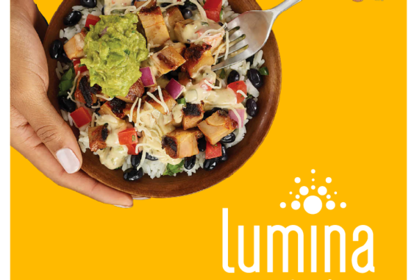 burrito bowl with fork on yellow background next to lumina foods logo