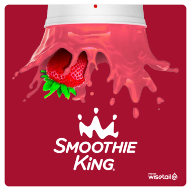 Smoothie king logo next to smoothie cup with smoothie flying out and strawberry, on red background