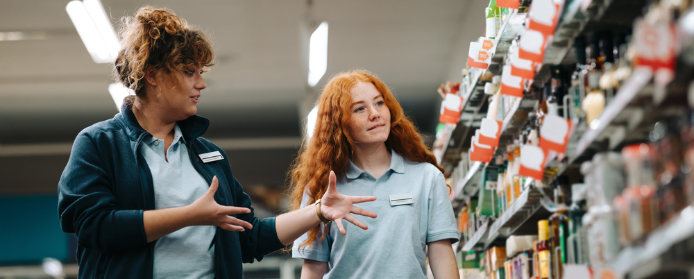 Photo: Grocery store manager training a new employee