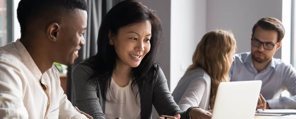 Photo: A diverse group of employees collaborate and learn together in the workplace.