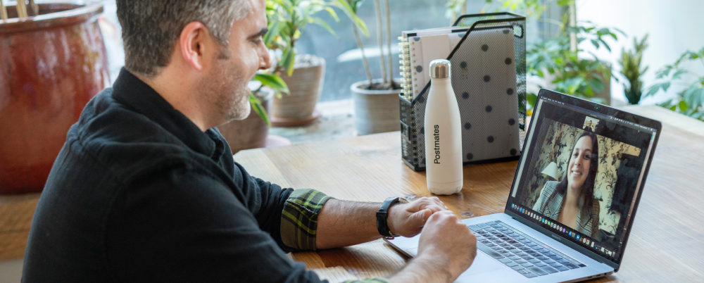 man looking at laptop on a zoom call