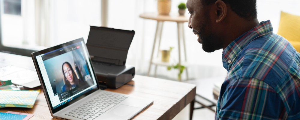 man looking at a computer on a zoom call