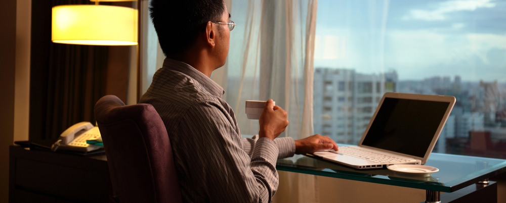 business man sit in a room and looking into the distance in hotel, concept of traveling business, dream, work at night etc