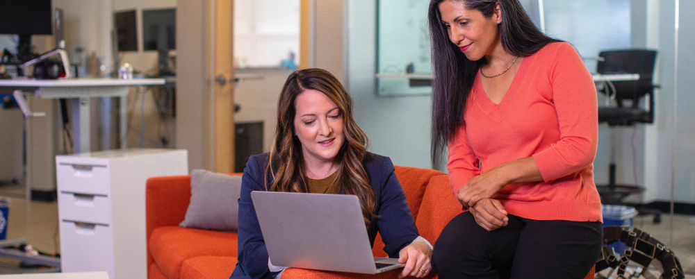 Two women observing a laptop screen