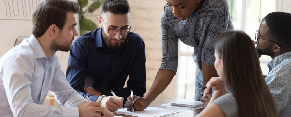 Group of people collaborating at a conference table setting