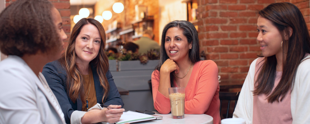 Group of coworkers discussing how to pivot over drinks and coffee