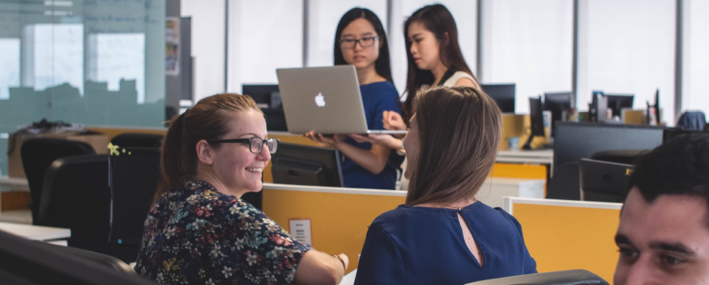 Open floor office setting with employees collaborating.