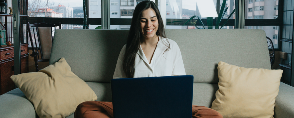 Woman using her laptop to engage with learning tools.