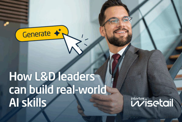 Man in business attire stands confidently by a staircase holding a tablet. Text reads "How L&D leaders can build real-world AI skills."