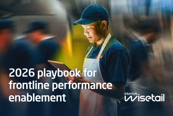 A focused worker in a cap and apron stands holding a tablet in a bustling, blurred environment. Text reads “2026 playbook for frontline performance enablement.” The atmosphere suggests dedication and efficiency.