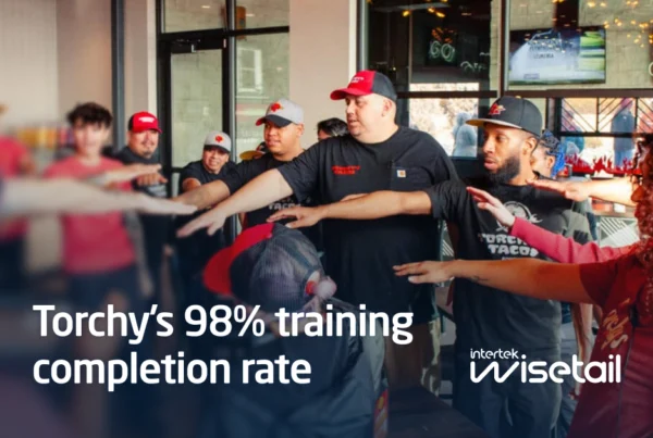 Bad Ass Coffee employees stand outside a café with text reading “Bad Ass Coffee’s franchise success driven by culture”